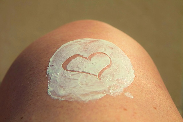 Picture of knee with circle of sunblock on it and heart drawn on sunblock to show self-love